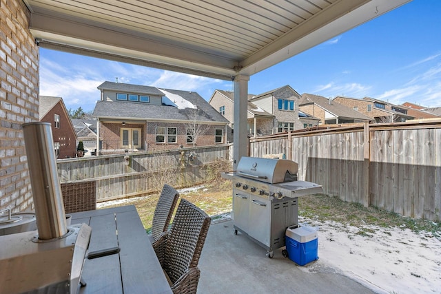 view of patio with grilling area, a fenced backyard, and a residential view