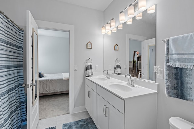 ensuite bathroom with tile patterned flooring, a sink, ensuite bath, and double vanity