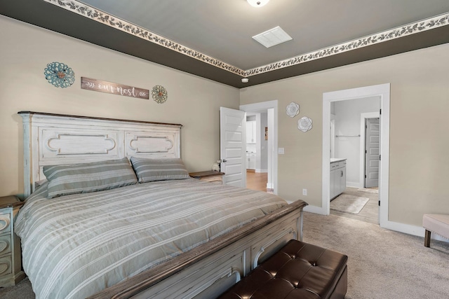 bedroom featuring light carpet, connected bathroom, and baseboards