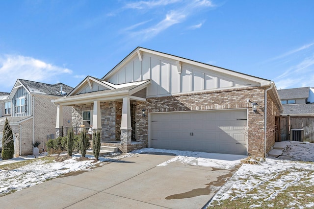 view of front of home featuring an attached garage, concrete driveway, board and batten siding, and brick siding