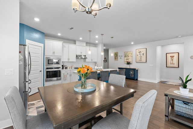 dining room with a chandelier, baseboards, dark wood finished floors, and recessed lighting