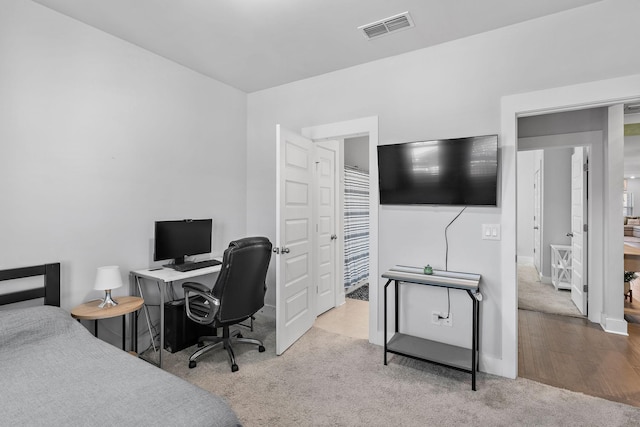 bedroom with light carpet and visible vents