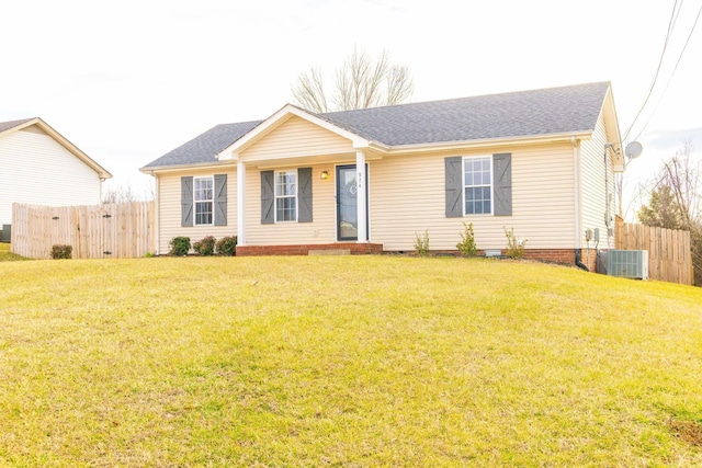 ranch-style home featuring central air condition unit, fence, and a front lawn