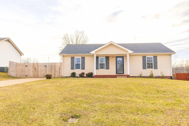 ranch-style home featuring a front yard and fence