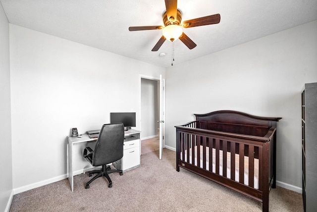 bedroom featuring light colored carpet, ceiling fan, and baseboards