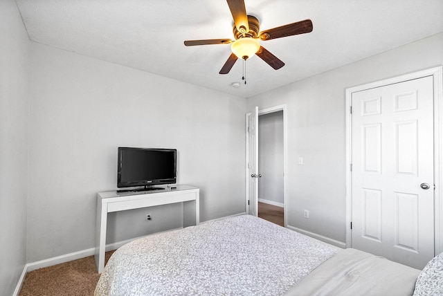 bedroom with ceiling fan, carpet flooring, and baseboards