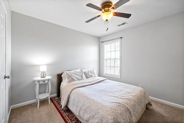 bedroom featuring ceiling fan, carpet flooring, visible vents, and baseboards