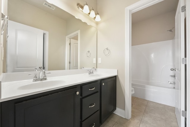 full bath with double vanity, visible vents, a sink, and tile patterned floors