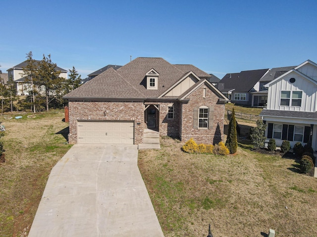 view of front of house featuring driveway, a garage, a shingled roof, brick siding, and a front yard