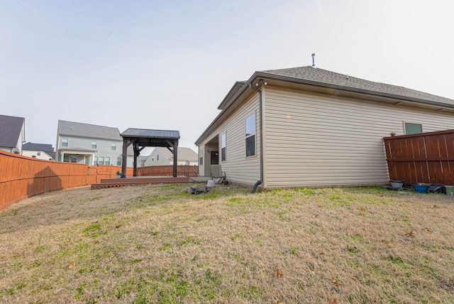 exterior space featuring a gazebo, a yard, and a fenced backyard