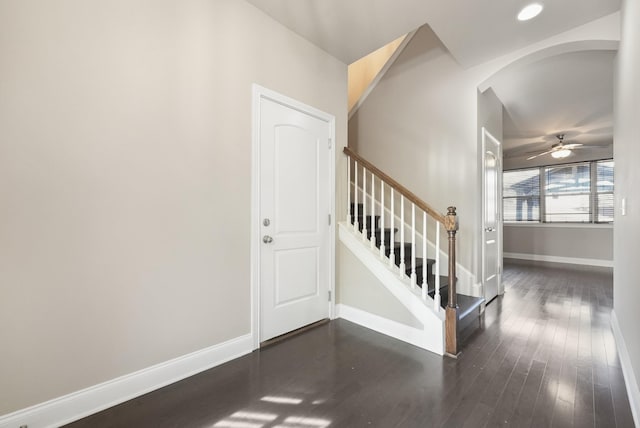 foyer with stairway, baseboards, and dark wood-style flooring