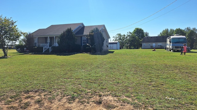 view of yard with a porch and a shed