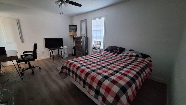 bedroom with a ceiling fan, baseboards, and dark wood-style flooring