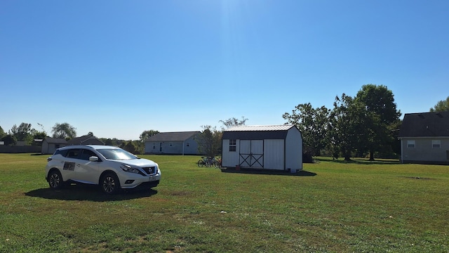 view of yard featuring a storage shed and an outbuilding