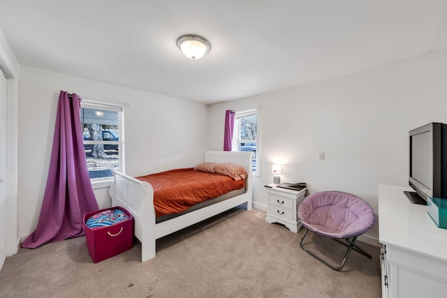 bedroom featuring light colored carpet