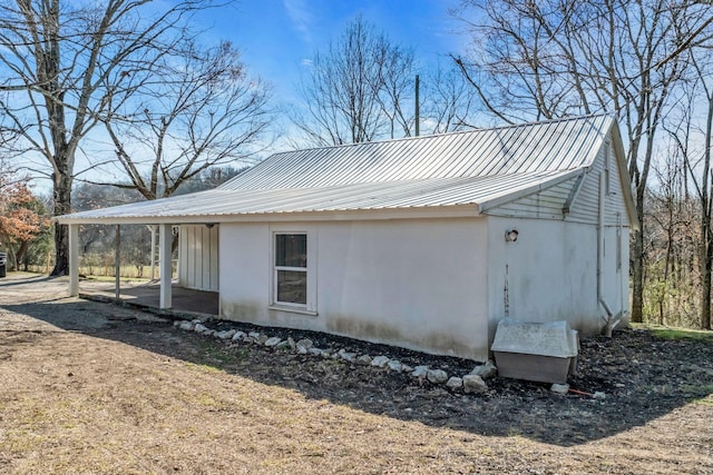 view of property exterior featuring stucco siding and metal roof