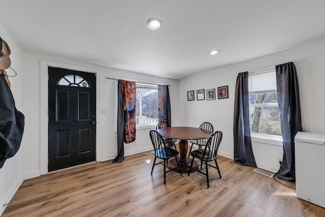 dining room with recessed lighting, light wood-style floors, visible vents, and a wealth of natural light