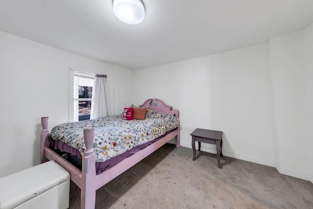 bedroom with baseboards and carpet floors