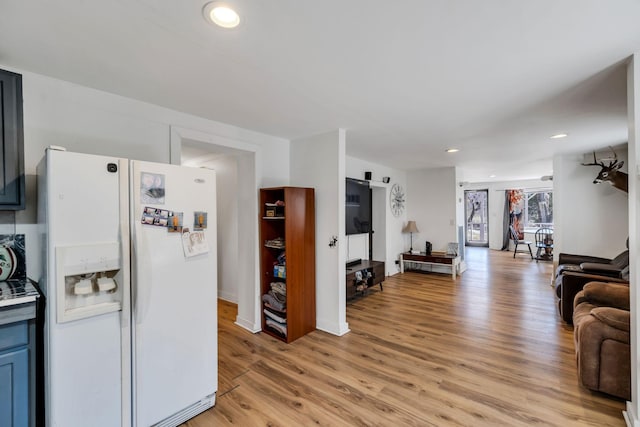 living area with light wood finished floors and recessed lighting