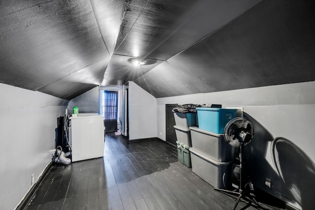 additional living space featuring baseboards, washer / dryer, vaulted ceiling, wood-type flooring, and a textured ceiling