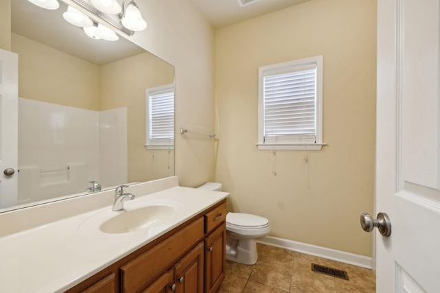 bathroom with tile patterned flooring, toilet, vanity, visible vents, and baseboards