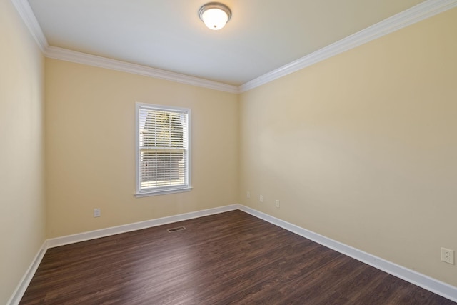 empty room featuring visible vents, baseboards, dark wood-type flooring, and ornamental molding