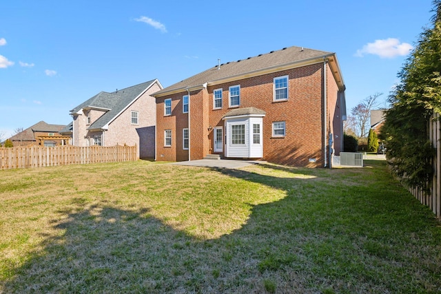 back of property featuring a yard, brick siding, and fence