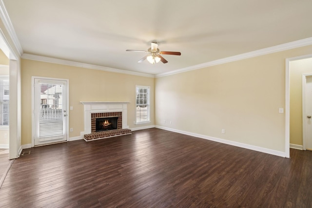 unfurnished living room with baseboards, plenty of natural light, dark wood finished floors, and crown molding