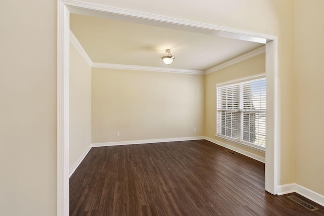 unfurnished room with baseboards, visible vents, dark wood-style flooring, and ornamental molding