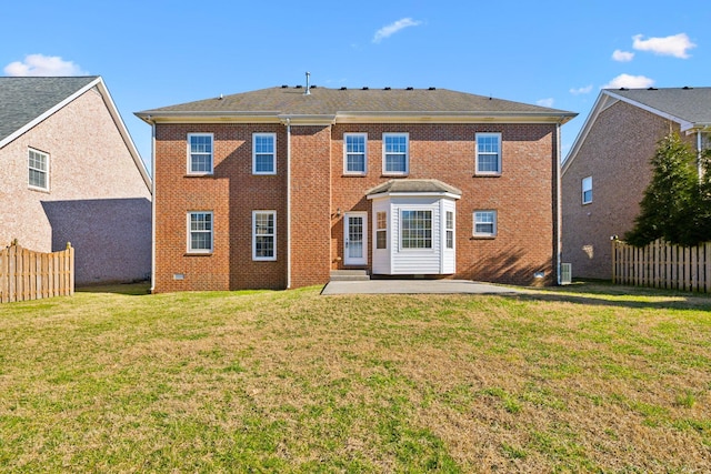 back of property with crawl space, fence, a yard, a patio area, and brick siding