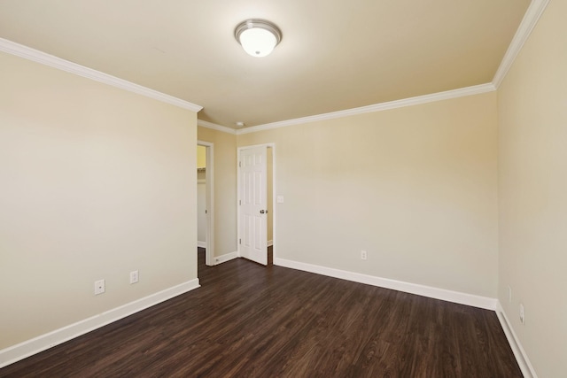 unfurnished room with ornamental molding, dark wood finished floors, and baseboards