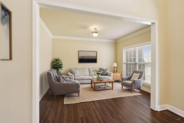 living room featuring dark wood-style floors, baseboards, ornamental molding, and visible vents