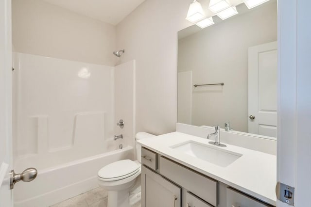 full bath featuring  shower combination, vanity, toilet, and tile patterned floors