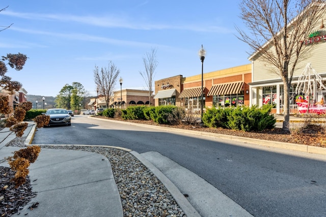 view of road with curbs and street lights