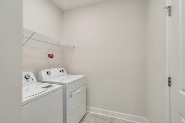 laundry room with laundry area, independent washer and dryer, and baseboards