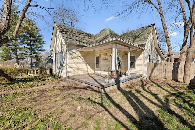 view of front of home featuring covered porch and fence