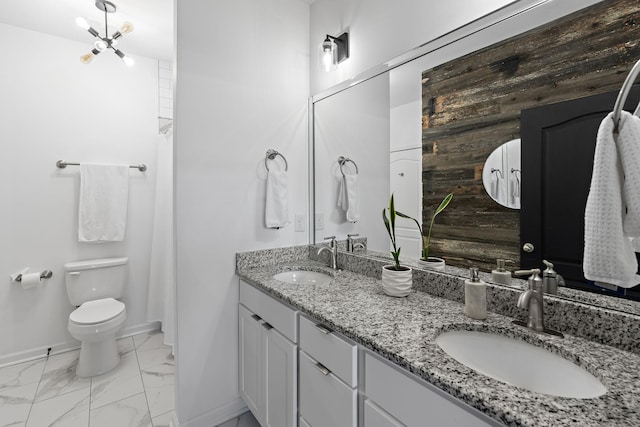 bathroom with marble finish floor, baseboards, and a sink