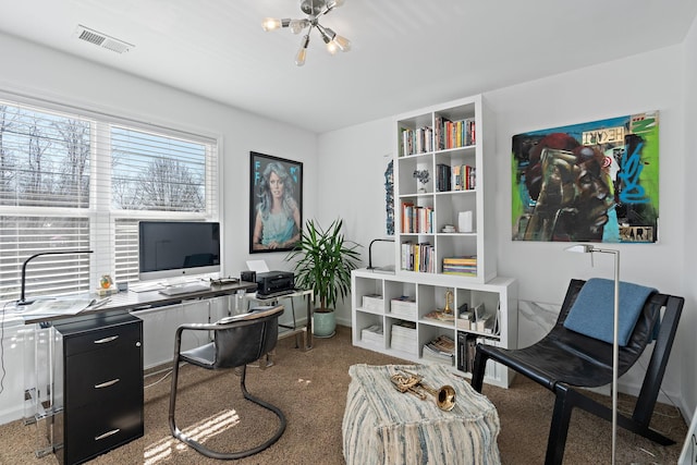 office space with carpet floors, a chandelier, visible vents, and baseboards