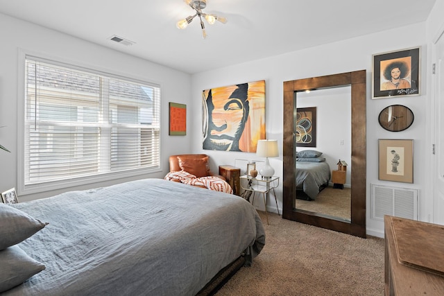 carpeted bedroom featuring visible vents