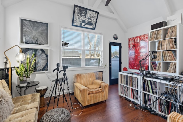 living area featuring vaulted ceiling and wood finished floors