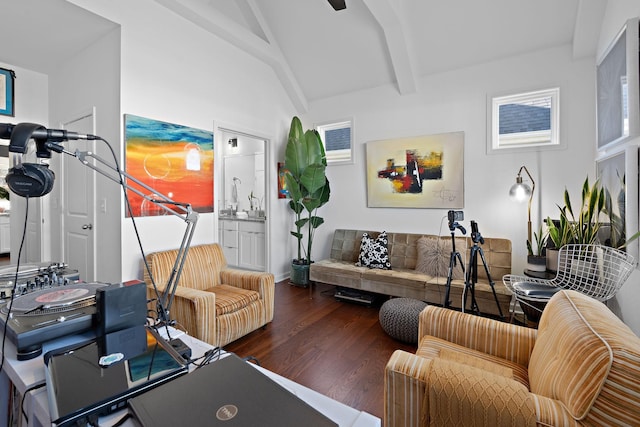 living room with vaulted ceiling with beams and wood finished floors