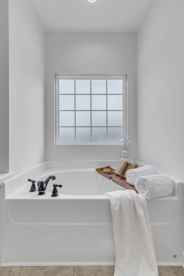 bathroom with a garden tub