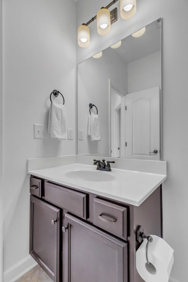 bathroom with vanity and baseboards