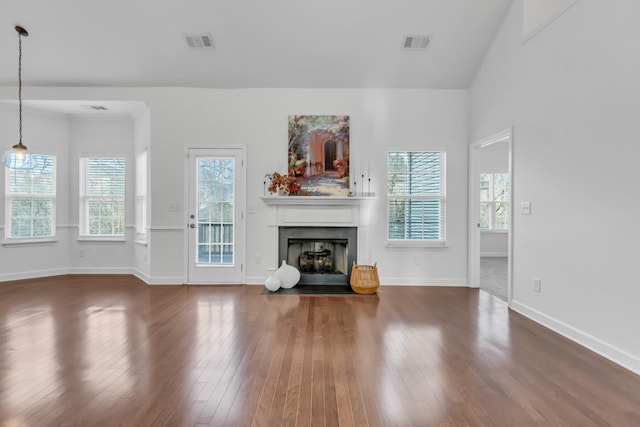 unfurnished living room featuring a fireplace, visible vents, and hardwood / wood-style floors