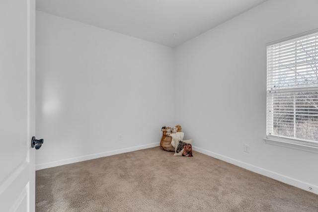 carpeted spare room with baseboards