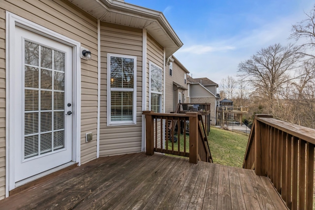 wooden terrace with a lawn