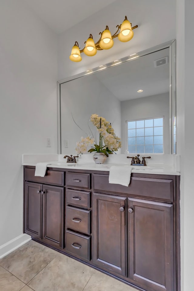 full bath with double vanity, tile patterned flooring, visible vents, and a sink