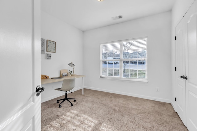 office area with carpet flooring, visible vents, and baseboards