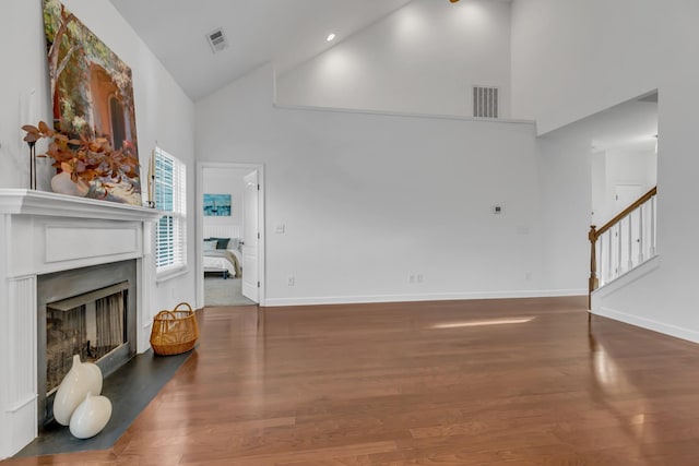 living area featuring a fireplace, wood finished floors, and visible vents