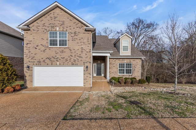 traditional-style home with a garage, brick siding, and driveway